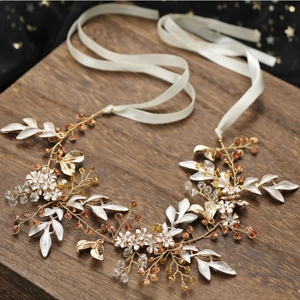 Handmade bridal headband with golden wire, enamel flowers and amber crystals on wood