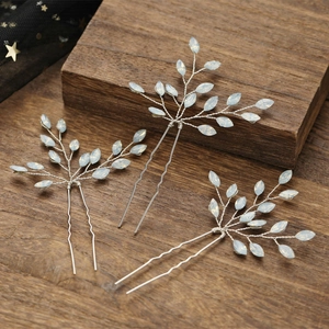 Detail of silver handcrafted U-shaped bridal hair pins with marquise opal stones