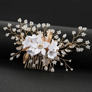 Exquisite bridal hair comb with gold wires, white lily flowers and sparkling rhinestones