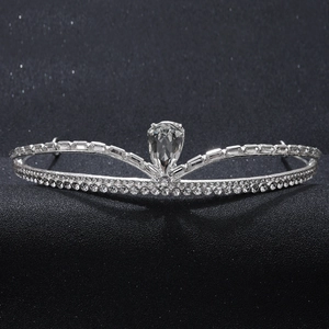 Elegant silver crown tiara with sparkling rhinestones and drop-shaped zircon on black background