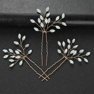 Three-piece set of golden U-shaped hair pins with white opal leaf accents for bridal styling