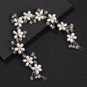 Elegant bridal pearl hair vine with crystal flower accents for wedding hair styling