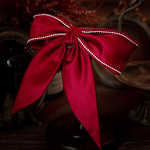 Elegant wine red satin bow bridal hair clip with pearl trim and long flowing ribbons