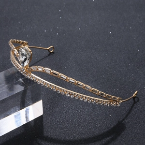 Elegant gold alloy crown headband with pear-shaped rhinestones on a black background