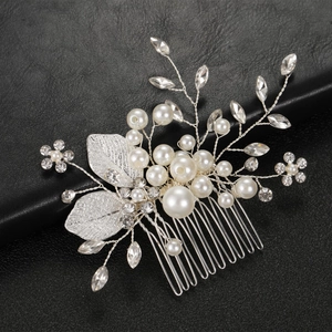 Detailed macro view of handmade silver hair comb with white pearls and crystals