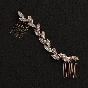 Elegant bridal hair comb with rhinestone leaf design and golden finish on black background