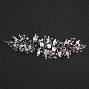 Silver bridal hair vine with white pearls and crystal flower accents on black background