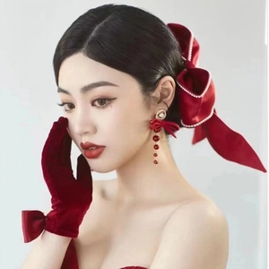 Elegant red satin bow hair clip with matching pearl tassel earrings and velvet gloves