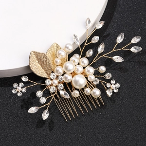 Detailed view of handmade golden leaf hair comb with white pearls and sparkling rhinestones