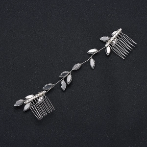 Silver bridal hair vine with grey leaf gems and dual combs on black glitter background