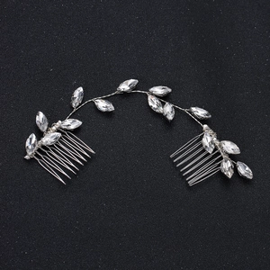Elegant bridal hair vine with marquise-cut crystals and silver combs on black background