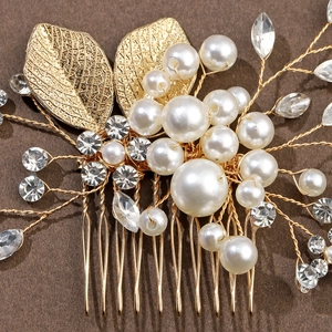 Detail of handmade gold hair comb with rhinestones, pearls and hollow leaf ornaments