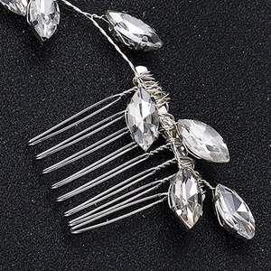 Macro view of bridal hair comb showing silver wire wrap and marquise-cut crystals