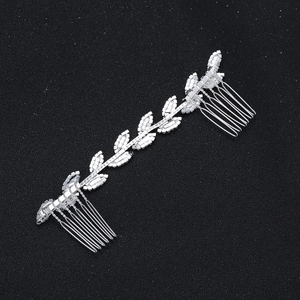 Detail of silver bridal hair comb featuring rhinestone leaf vine design on black background