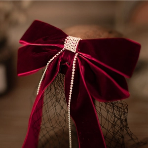 Elegant burgundy velvet bow bridal headpiece with sparkling crystal fringe and black mesh veil