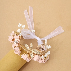 Elegant floral wrist corsage with pink chiffon flowers, gold leaves and pearls for bridesmaids