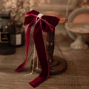 Vintage burgundy velvet bridal bow hair accessory with rhinestones and mesh veil detail
