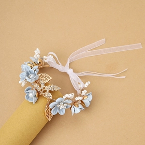 Floral bridal wrist corsage with light blue flowers, pearls and pink silk ribbons