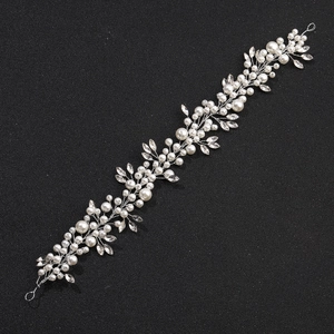 Silver bridal hair vine with marquise crystals and pearls on a black background