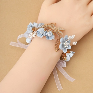 Elegant light blue floral wrist corsage with golden leaves and pearls for bridesmaids