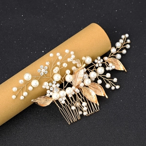 Golden leaf and pearl bridal hair comb with rhinestones on a premium black background