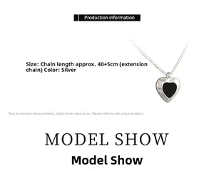 Detail showing heart pendant with black enamel center and 40cm silver metal chain