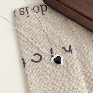 Minimalist silver heart pendant necklace with black enamel inlay and wavy texture