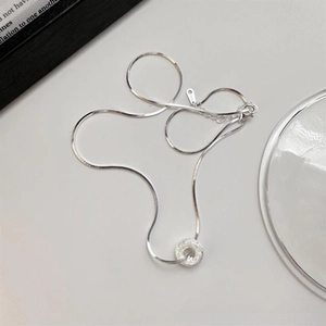 Close-up of S925 sterling silver donut pendant with frosted texture on snake chain