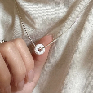 Minimalist silver snake chain necklace featuring a frosted sandblast donut ring pendant
