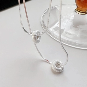 Minimalist silver frosted donut pendant necklace with sleek snake chain for women