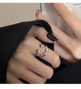 Detailed macro view of the silver smiley face ring with polished adjustable open band