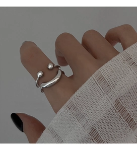 Close-up of minimalist silver smiling face ring with adjustable open band for women