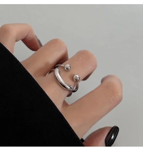 Close-up of minimalist smiling face open ring in silver finish worn on finger
