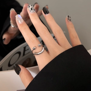 Minimalist silver smiley face open ring with adjustable band shown on a finger