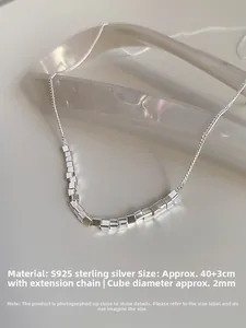 Macro detail of S925 sterling silver chain featuring minimalist 2mm square beads