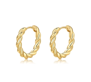 Detailed close-up of golden twisted rope hoop earrings featuring a polished mirror finish