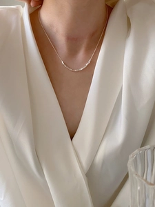 Minimalist S925 sterling silver cube bead necklace worn on a white V-neck garment