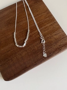Detail of S925 sterling silver cube pendant necklace with heart tag and hallmark