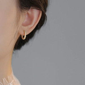 Elegant gold twisted rope hoop earrings for women featuring vintage French design on model