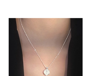 Detailed view of an S925 sterling silver rose pendant on a delicate water wave chain