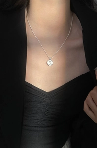 Close-up of S925 silver water wave chain with a detailed rose flower relief pendant