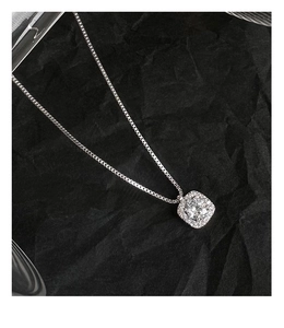 Macro shot of s925 sterling silver box chain necklace with radiant square diamond pendant