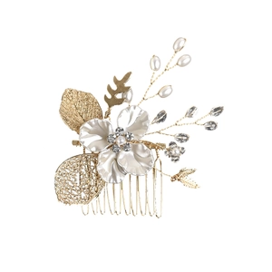 Elegant gold leaf hair comb with white enamel flower, pearls, and crystals for bridal styling
