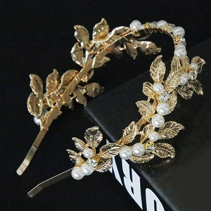 Detailed macro of golden baroque leaf headband with elegant pearls and sparkling rhinestones