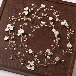 Elegant bridal hair vine with white pearls and small flowers on gold wire headband