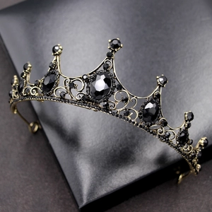 Macro shot of Baroque black tiara with antique gold metalwork and sparkling rhinestones