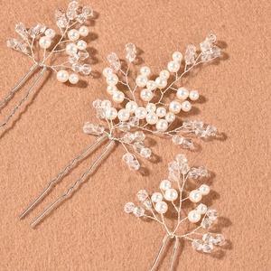 Detail of three bridal hair pins with white pearls and crystals on silver wire