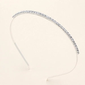 Close-up of bright silver bridal headband featuring a neat row of square clear rhinestones
