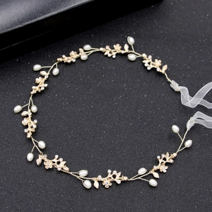 Elegant gold bridal headband with pearls, crystals, and organza ribbons on black background