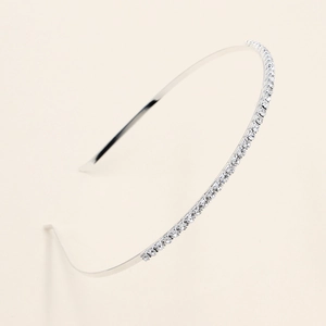 Close-up of sparkling crystals on thin silver bridal headband for wedding hairstyles